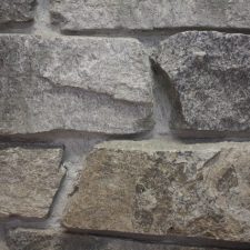 A raised stone veneer with defined mortar lines.
