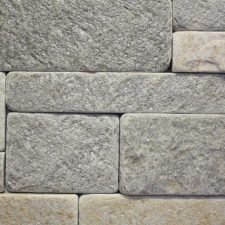 A light stone veneer with alternating stone alignments.