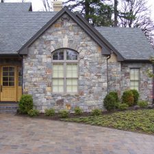 A stone house with a beautiful mosaic veneer.